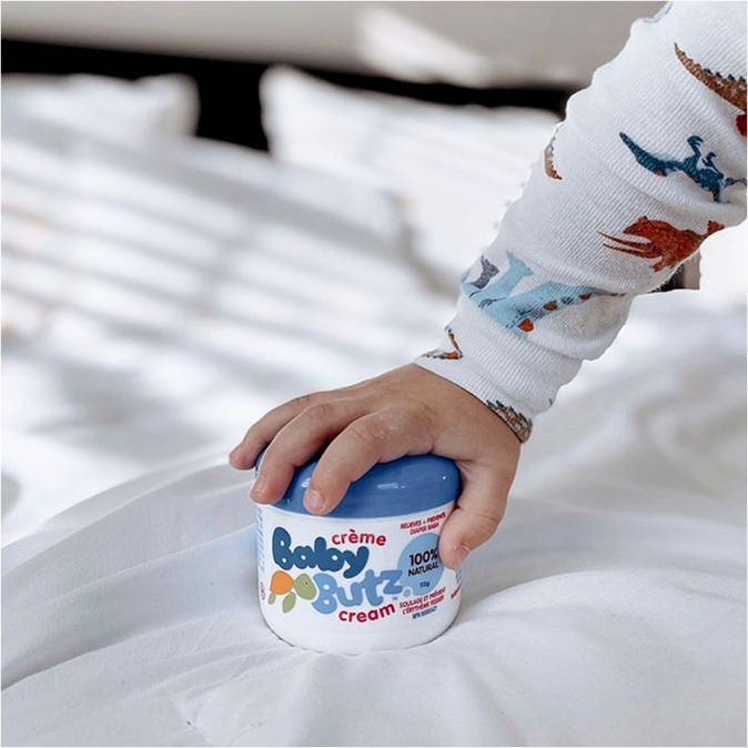 A baby holding the product